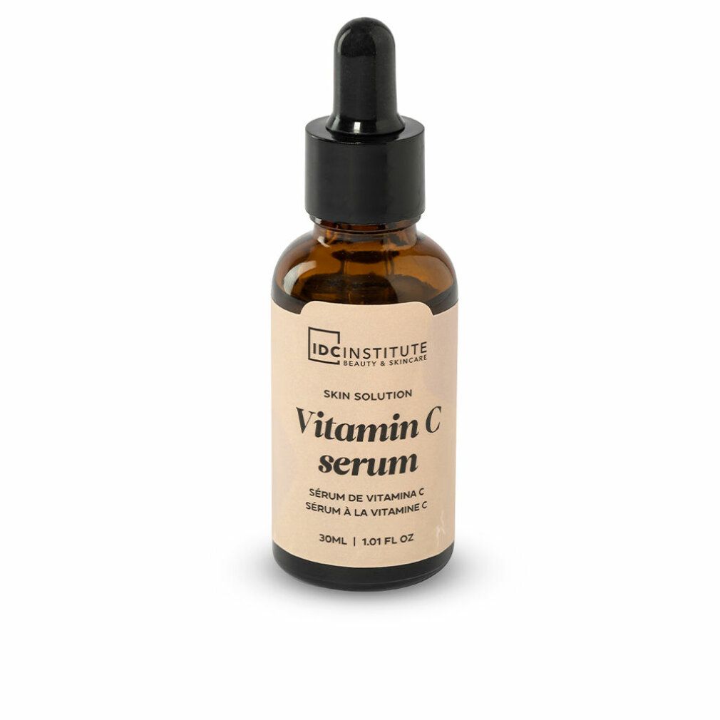 Braune Glasflasche mit schwarzem Deckel und Pipette. Etikett mit "Vitamin C serum" und "IDC INSTITUTE".