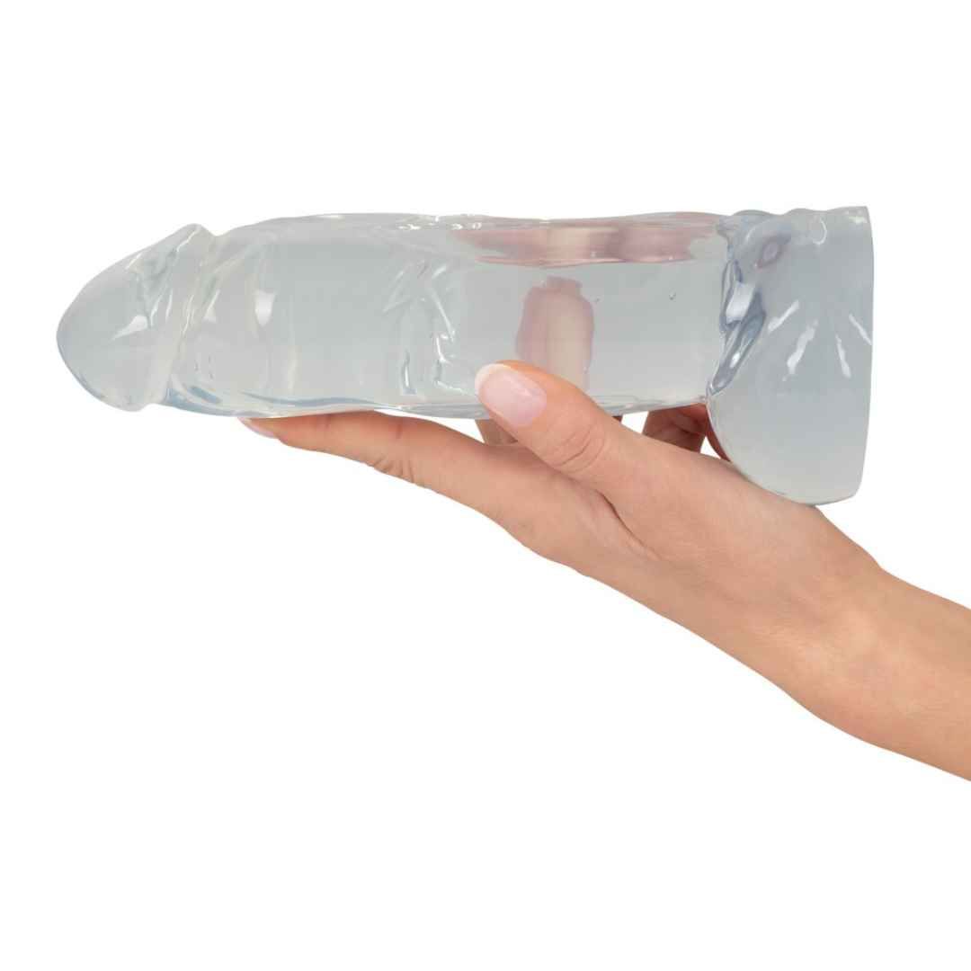 Transparentes, dickförmiges Objekt. Geriffelte Oberfläche, in Hand gehalten.