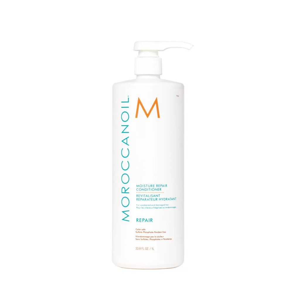 Weiße Flasche mit Pumpe. Aufschrift: Moroccanoil, M-Logo, Revitalisant, Repair. Text in Englisch. Orangefarbener Aufkleber.