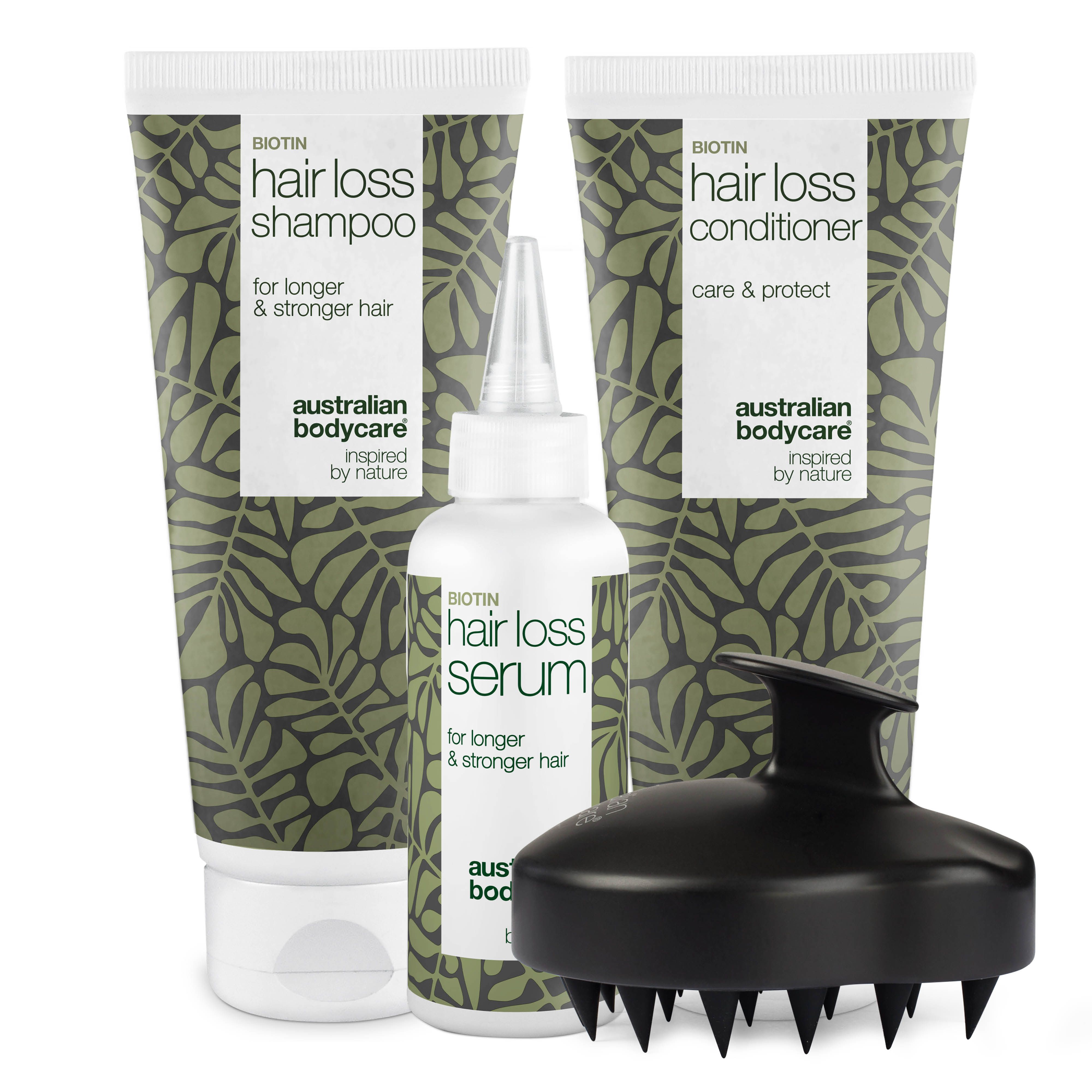 Shampoo, Conditioner und Serum gegen Haarausfall. Schwarze Kopfhautbürste. Produkte mit weißer Schrift.