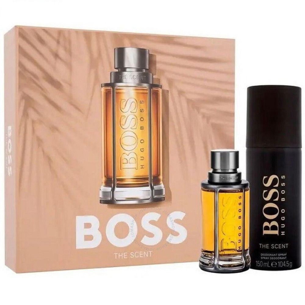 Geschenkset mit Flakon und Deospray. Flakon mit goldfarbener Flüssigkeit. Deospray schwarz mit goldener Schrift. Verpackung mit Logo.