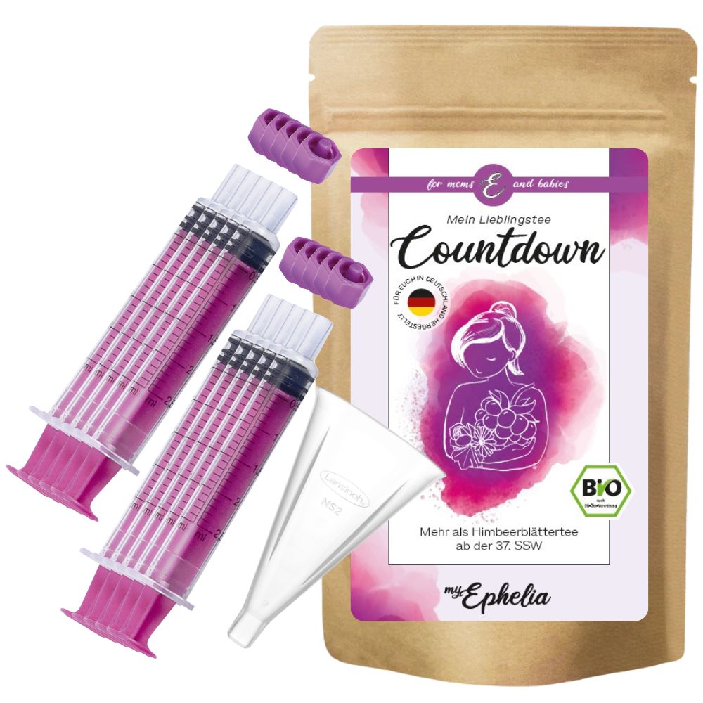 Braune Papiertüte, Kolostrumspritzen, Trichter und Zubehör. Auf der Tüte steht 'Countdown' und eine Abbildung einer Frau mit Himbeeren.