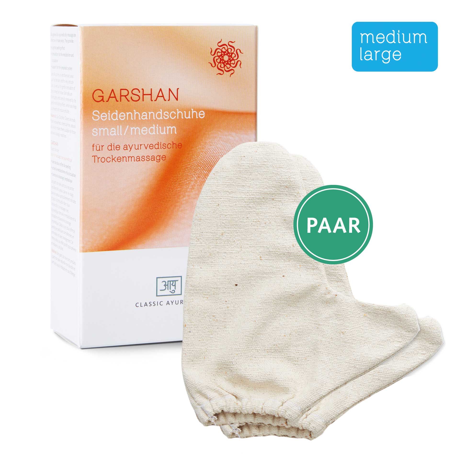 Garshan Seidenhandschuh small/medium. Paar weiße Handschuhe neben Verpackung. Text: Classic Ayurveda, für ayurvedische Trockenmassage.