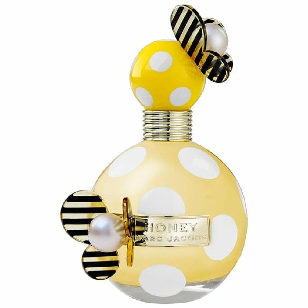 Gelber Flakon mit weißen Punkten, goldfarbenem Hals und Deckel. Schwarze und weiße Dekorationen. "HONEY" und "MARC JACOBS" Schriftzug.