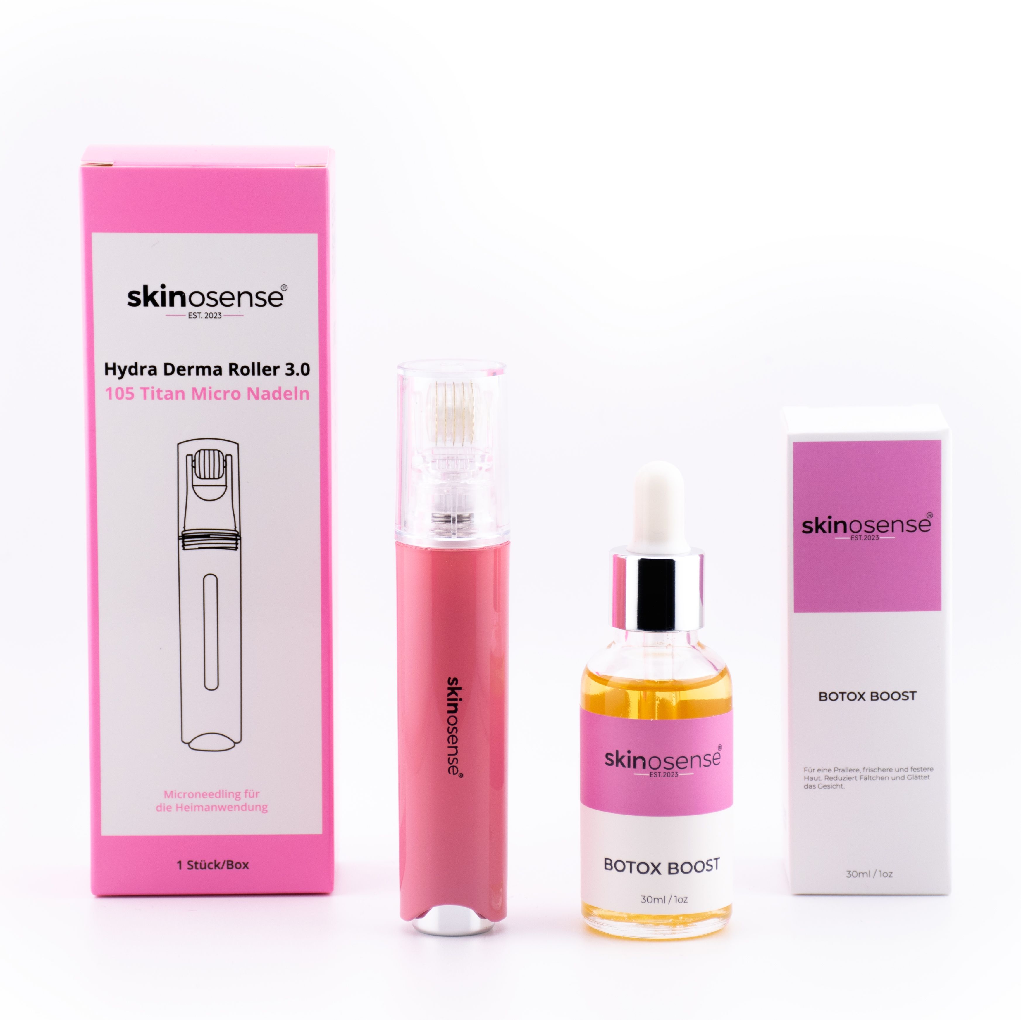 Set mit pinkfarbener Verpackung. Enthält Derma Roller, Serumflasche und zwei Schachteln. Aufdrucke: Skinosense, Botox Boost.