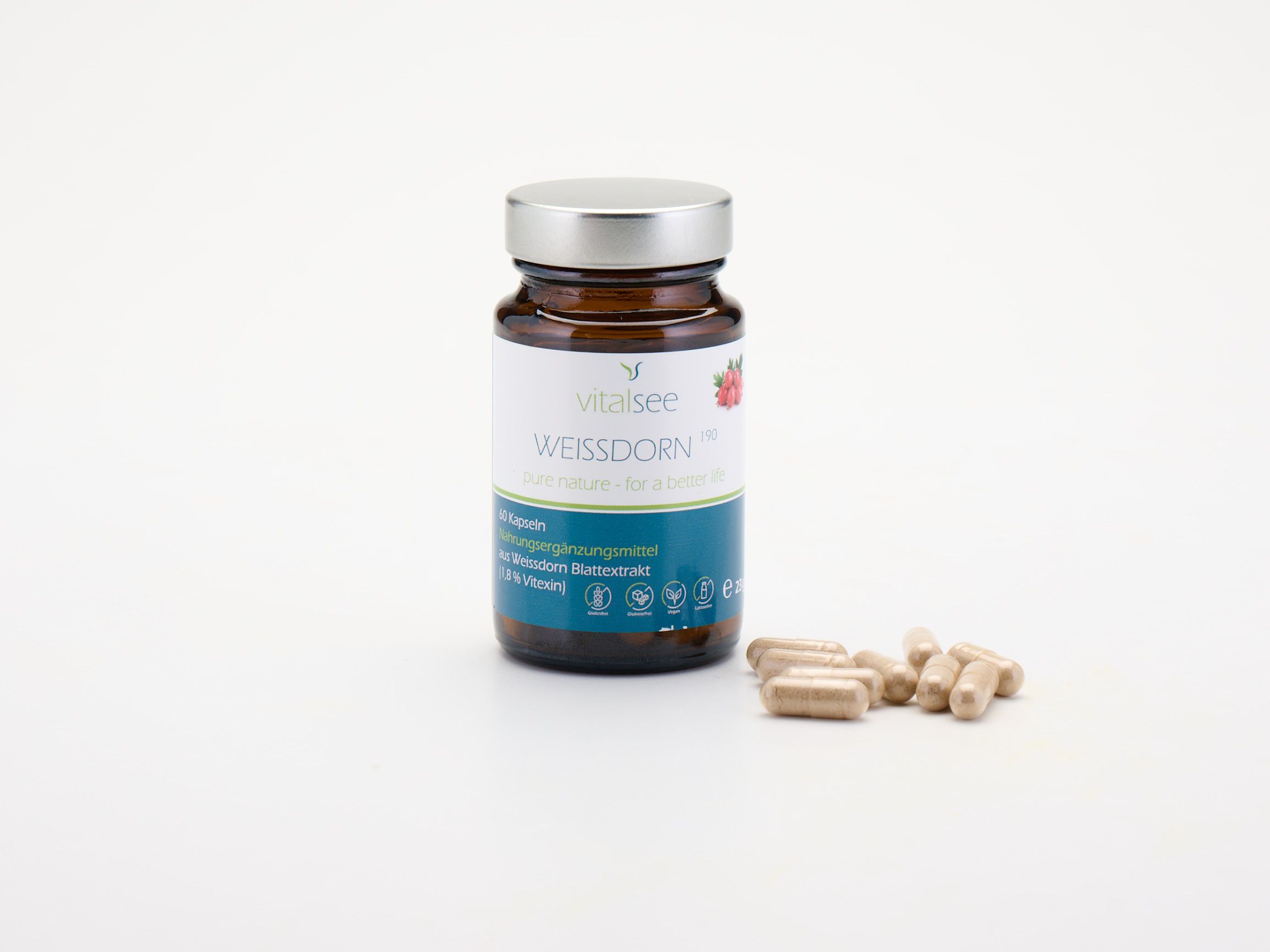 Braune Glasflasche mit silbernem Deckel und Kapseln daneben. Weißes Etikett mit Produktnamen und Marke.