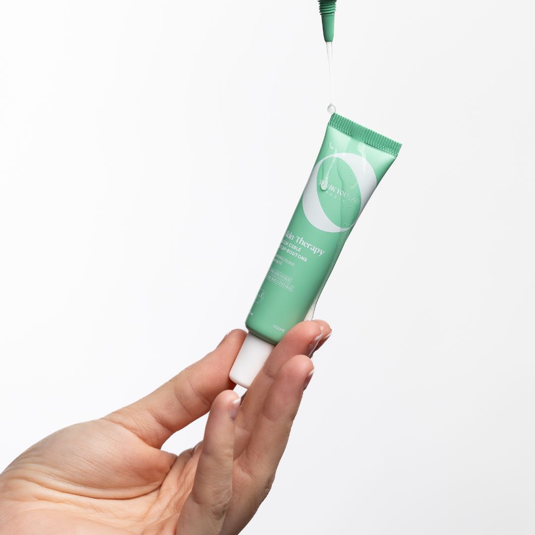 Grüne Tube, Tropfen. Produkt wird gehalten. Text: Skin Therapy, Cure & Routine.