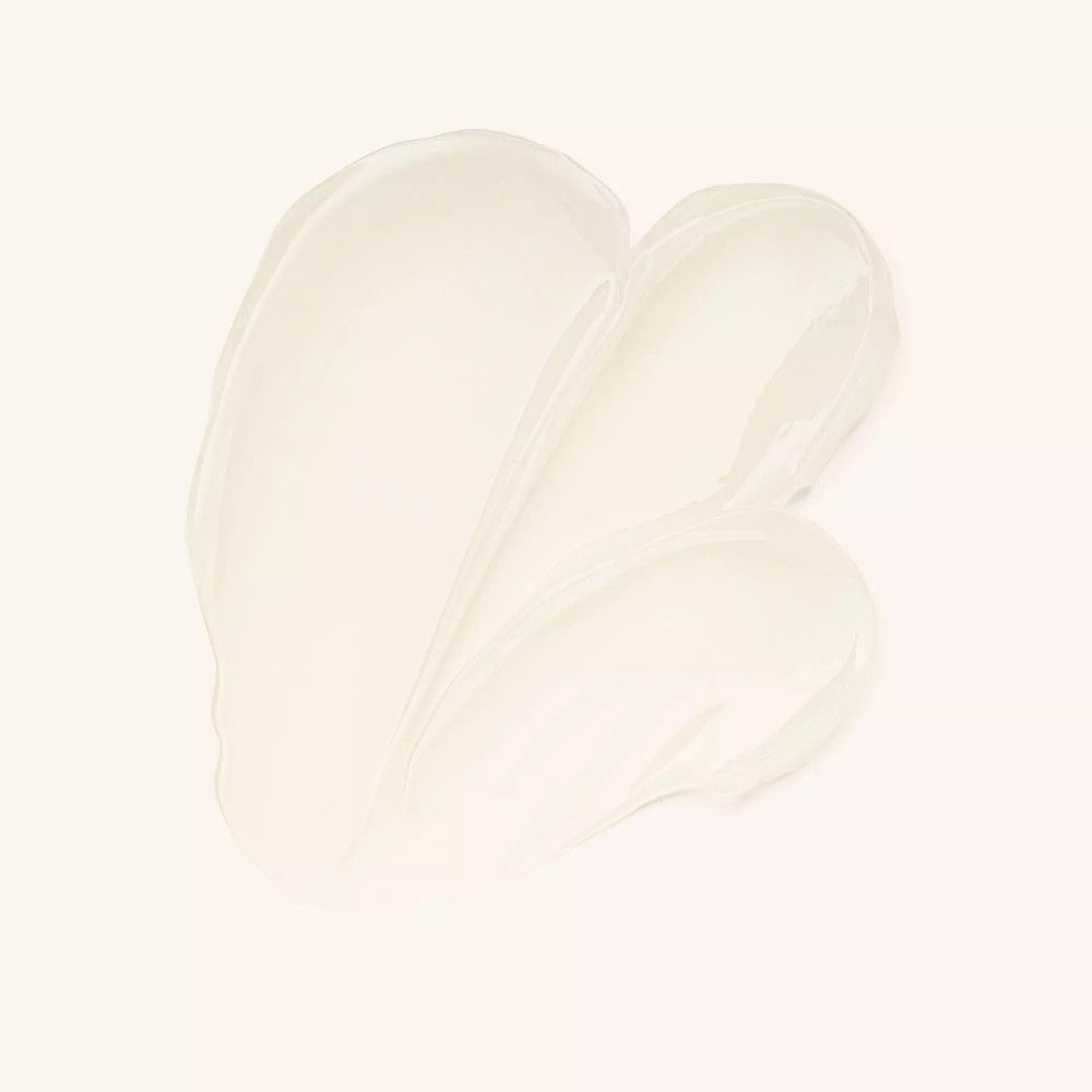 Creme-Textur, hellbeige, in wellenförmigen Strichen auf hellem Hintergrund. Produkt-Textur.