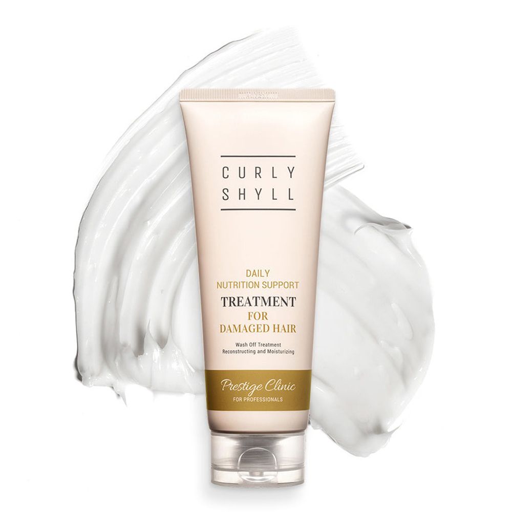 Tube auf weißer Creme. Aufschrift: CURLY SHYLL, TREATMENT FOR DAMAGED HAIR. Untertitel: Prestige Clinic.