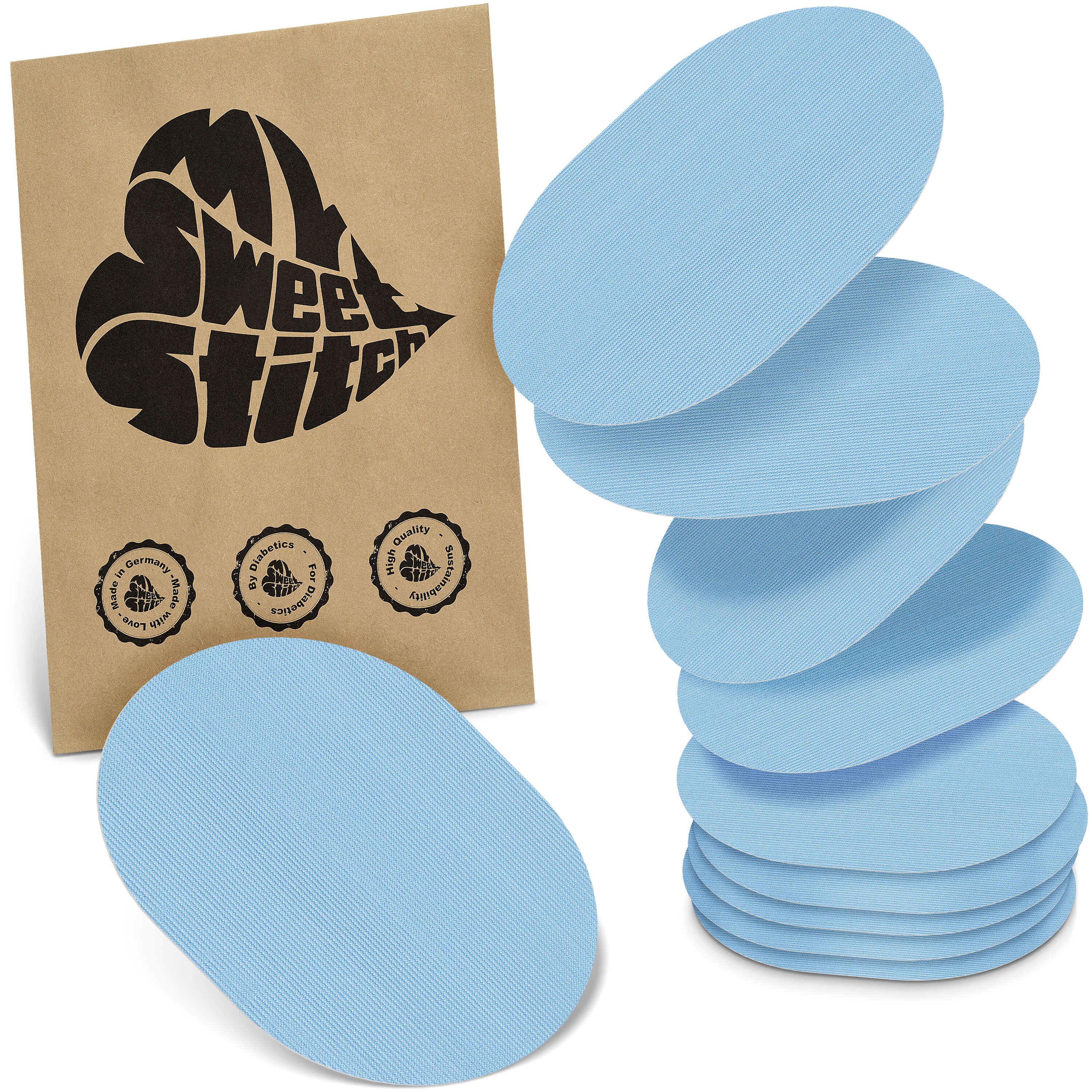 Hellblaue, ovale Pflaster. Auf brauner Verpackung steht "MySweetStitch". Siegel: "Made in Germany", "Bio Balance", "High Quality".