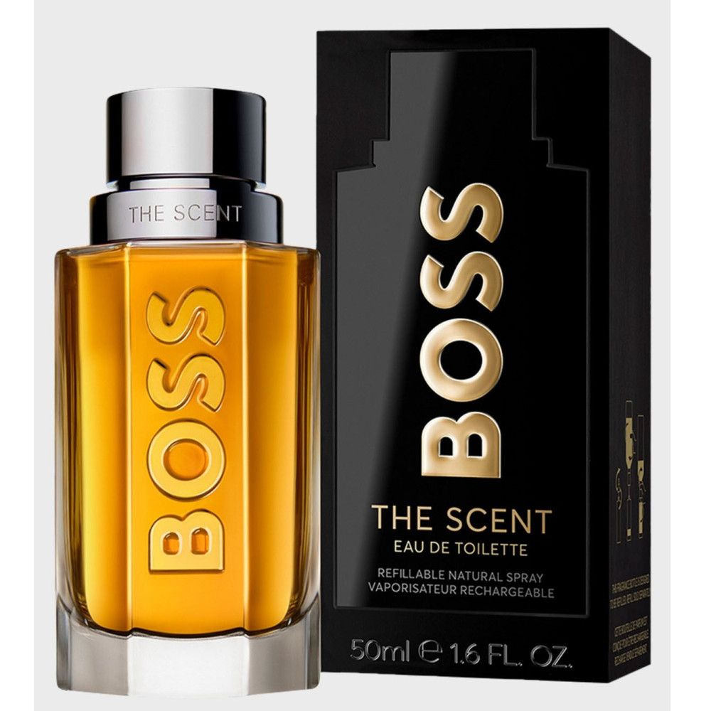Flakon und schwarze Verpackung. Goldfarbene Flüssigkeit. Silberner Verschluss. BOSS-Schriftzug. THE SCENT-Aufdruck.