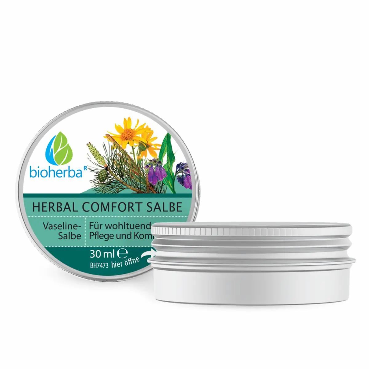 Geöffnete Dose mit Etikett. Text: Bioherba Herbal Comfort Salbe. Vaseline. 30 ml. Pflanzenabbildung. Dose aus Metall.