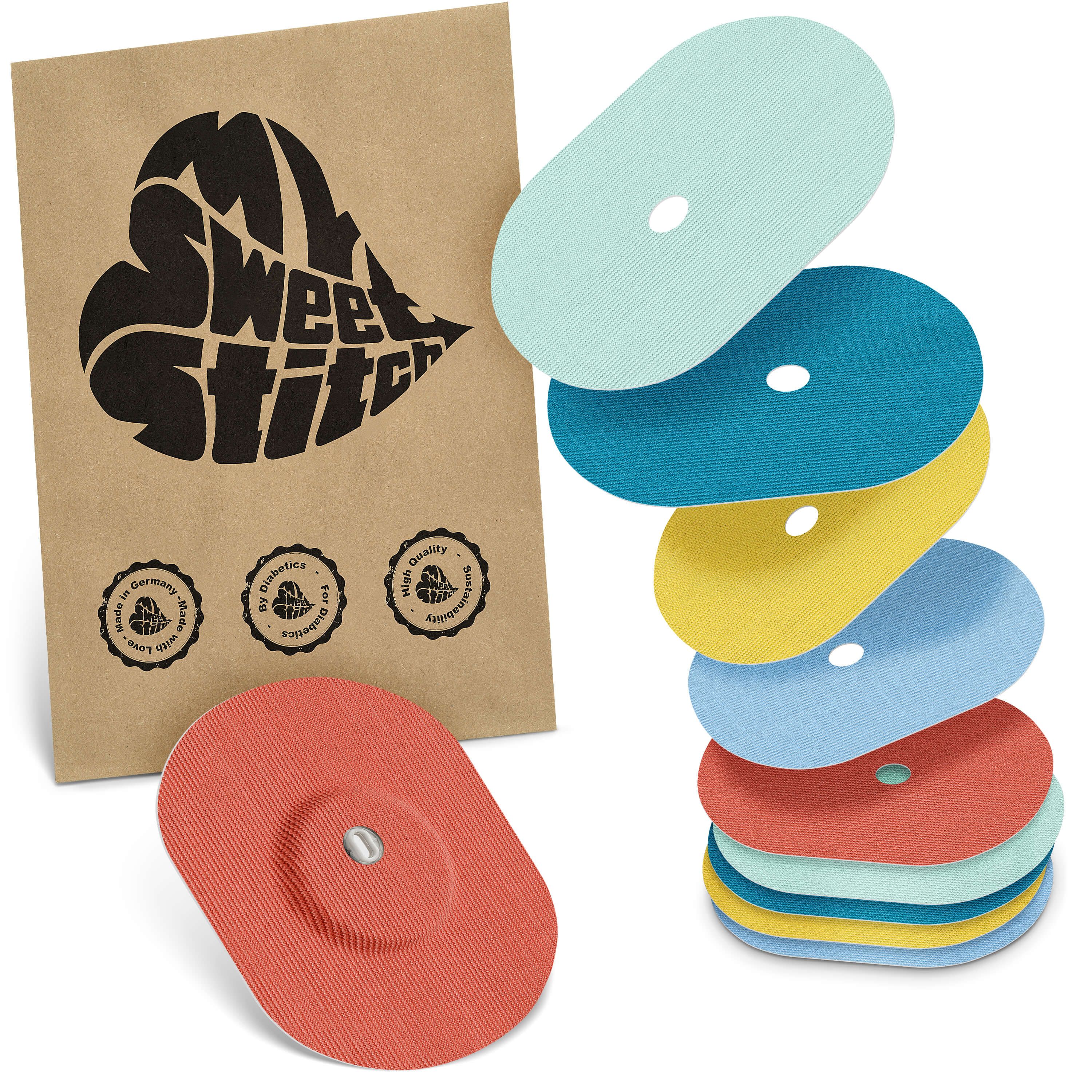 Ovale Pflaster in verschiedenen Farben. Braune Papiertüte mit Logo. Rotes Pflaster mit rundem Mittelteil und silbernem Element.