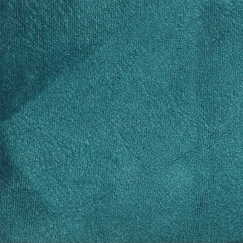 Stoffmuster in Petrol. Nahaufnahme eines strukturierten Stoffes. Textur mit Falten und Schatten.