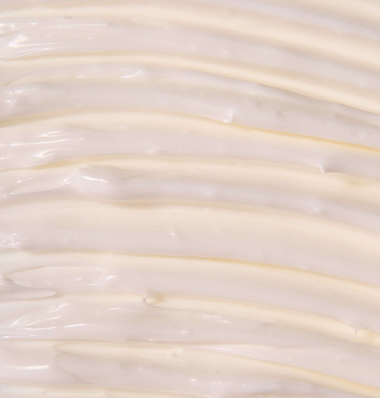 Nahaufnahme von Creme. Wellenförmige Textur. Cremefarbene Farbe.