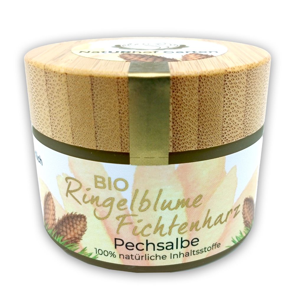 Runde Dose mit Holzdeckel. Aufschrift: BIO Ringelblume Fichtenharz Pechsalbe. 100% natürliche Inhaltsstoffe. Goldfarbener Streifen.
