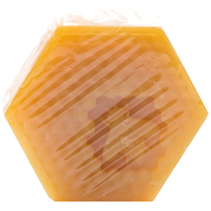 Seife in sechseckiger Form, in transparente Folie verpackt. Gelbliche Farbe. Diagonale Streifen auf der Folie.