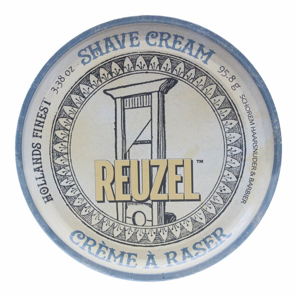 Nahaufnahme einer runden Dose mit Aufschrift "Shave Cream" und "Reuzel". Blaue Dose mit goldenem Deckel. Text in Englisch und Französisch.