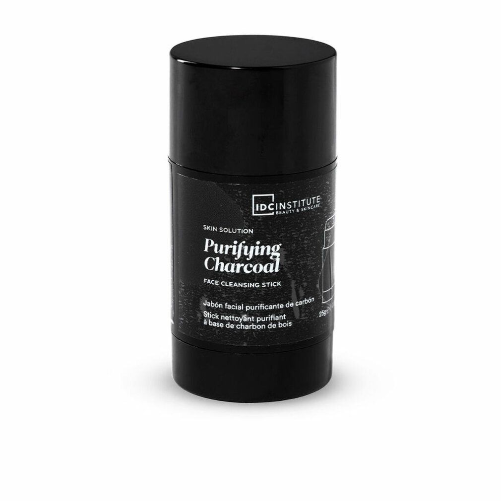 Schwarzer Reinigungsstick. Aufschrift: Purifying Charcoal, IDC INSTITUTE. Zylinderförmige Verpackung.