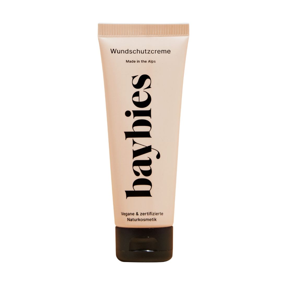 Beige Tube mit schwarzem Deckel. Aufschrift "baybies" und "Wundschutzcreme". Vegan & zertifizierte Naturkosmetik.
