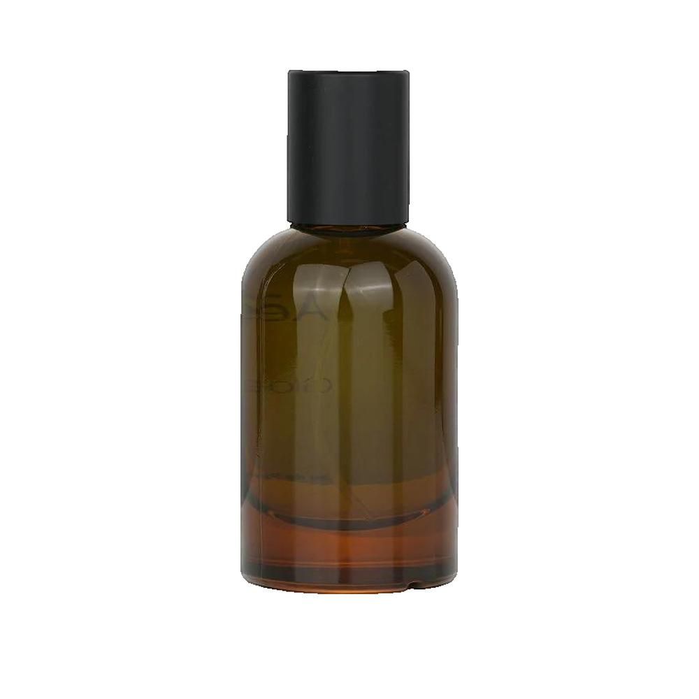 Braune Glasflasche mit schwarzem Deckel. Klarin-Logo auf dem Etikett. Parfümflasche.