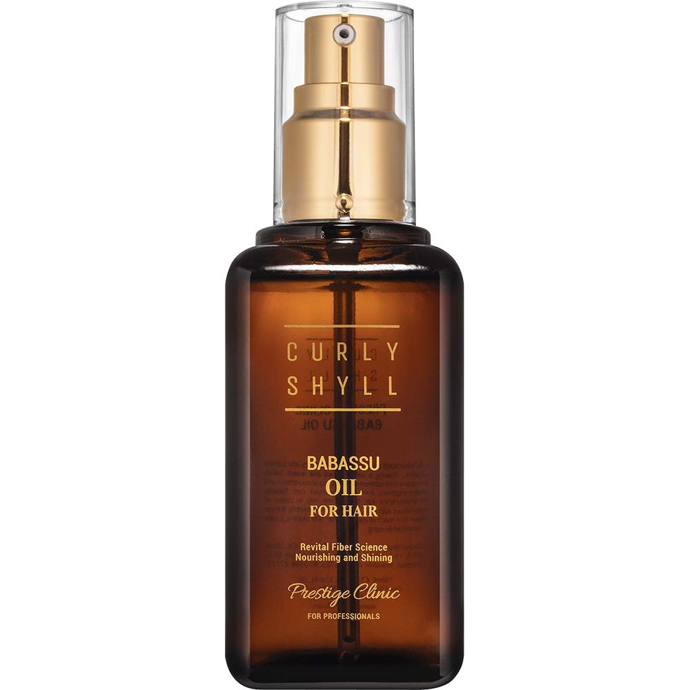 Braune Glasflasche mit goldfarbenem Sprühkopf. Aufschrift: CURLY SHYLL Babassu Oil for Hair. Prestige Clinic.