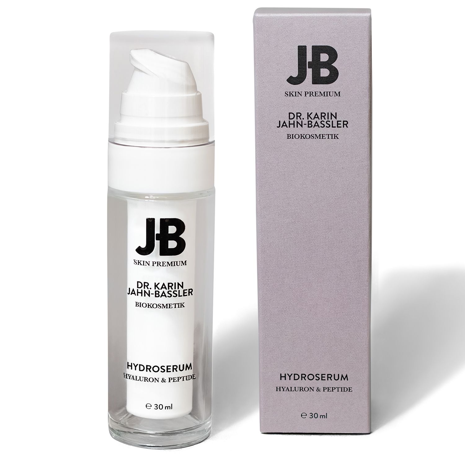 Transparente Flasche mit weißem Pumpkopf und grauer Schachtel. Aufschrift: JB SKIN PREMIUM, DR. KARIN JAHN-BASSLER, HYDROSURUM, Hyaluron & Peptide. E 30 ml.