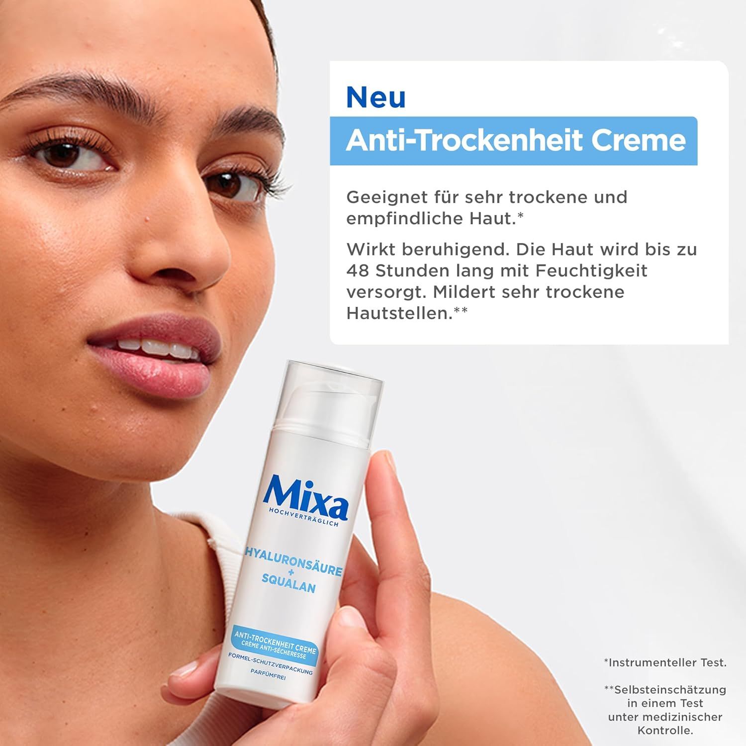 Frau hält eine weiße Creme-Flasche. Aufschrift: Mixa, Hyaluronsäure, Squalane. Text: Anti-Trockenheit Creme. Geeignet für trockene Haut.
