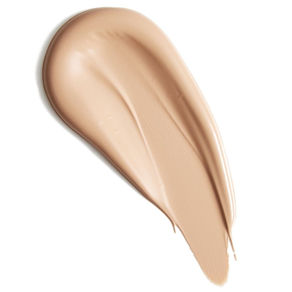 Beigefarbener Concealer-Strich auf weißem Hintergrund. Textur sichtbar.