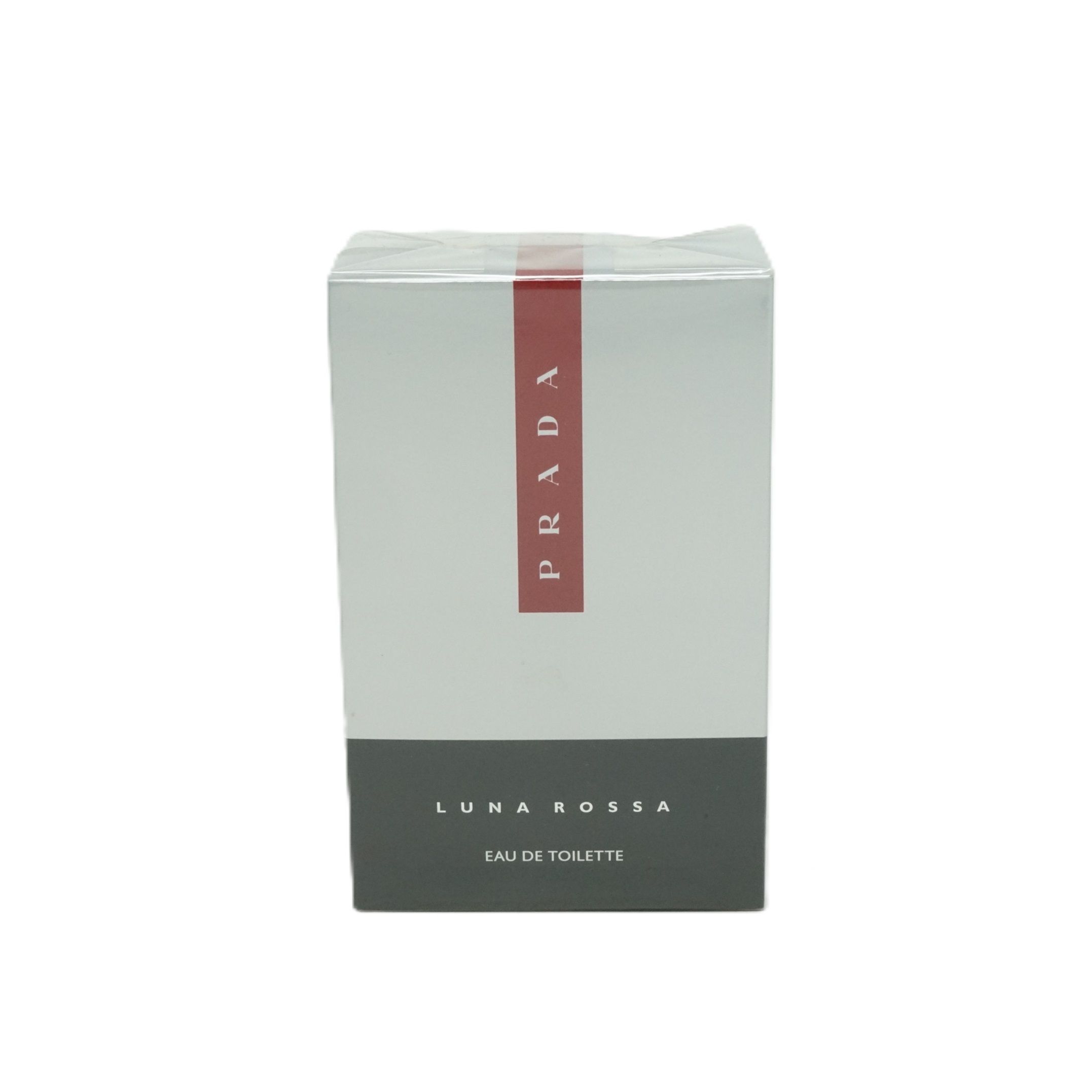Verpackung von Prada Luna Rossa Eau de Toilette. Weißer Karton mit rotem Prada-Streifen. Schwarzer Boden mit Produktbezeichnung.