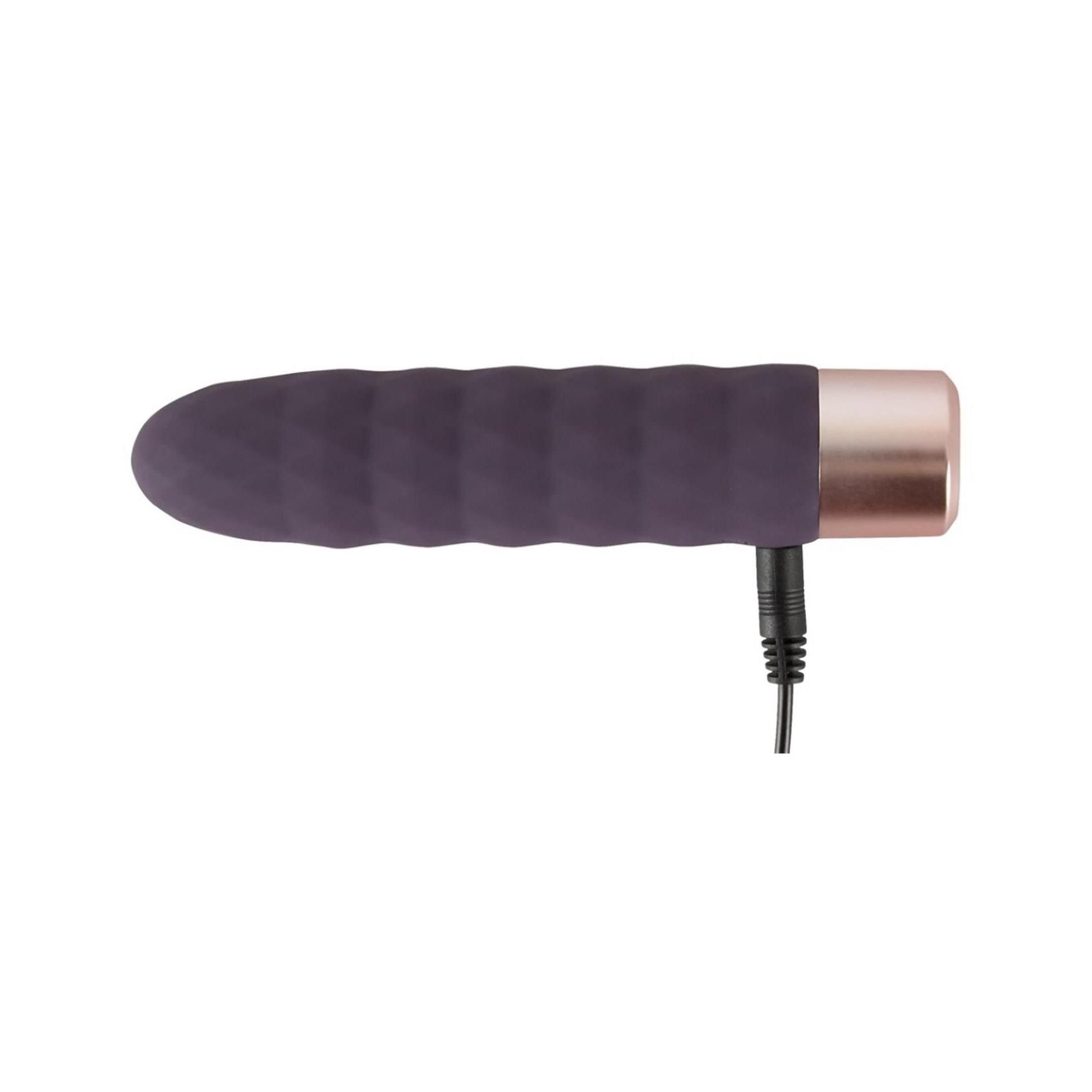Dunkelvioletter Vibrator mit Kabel. Goldfarbener Sockel. Geriffelte Oberfläche. Zylindrische Form.