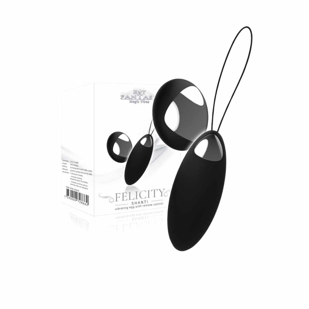 Schwarzes Ei-förmiges Wellness-Produkt mit Fernbedienung. Aufschrift: FELICITY SHANTI. Verpackung mit Logo und Produktinformationen.