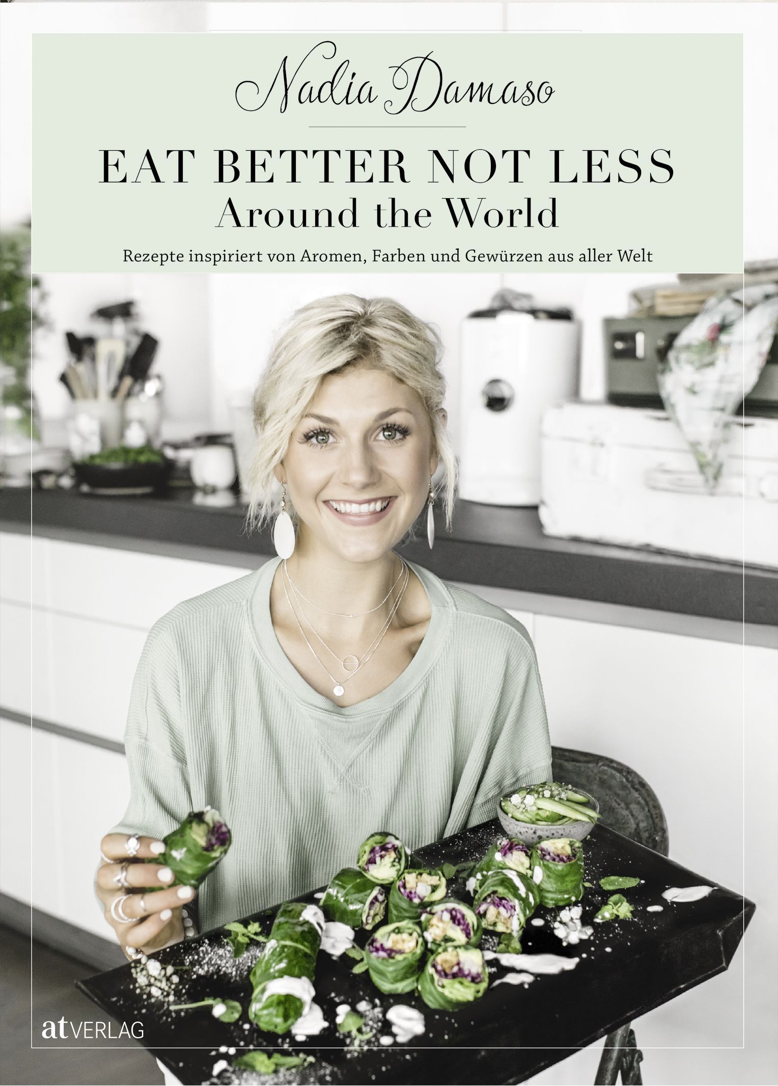 Buchcover mit Titel "EAT BETTER NOT LESS Around the World". Autorin Nadia Damaso. Frau hält Teller mit Speisen.