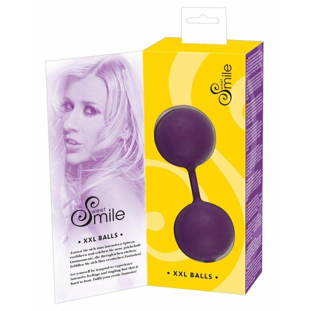 Verpackung von Sweet Smile XXL Balls. Lila Kugeln, gelbe Box mit Produktbild. Beilage mit Frauenporträt.