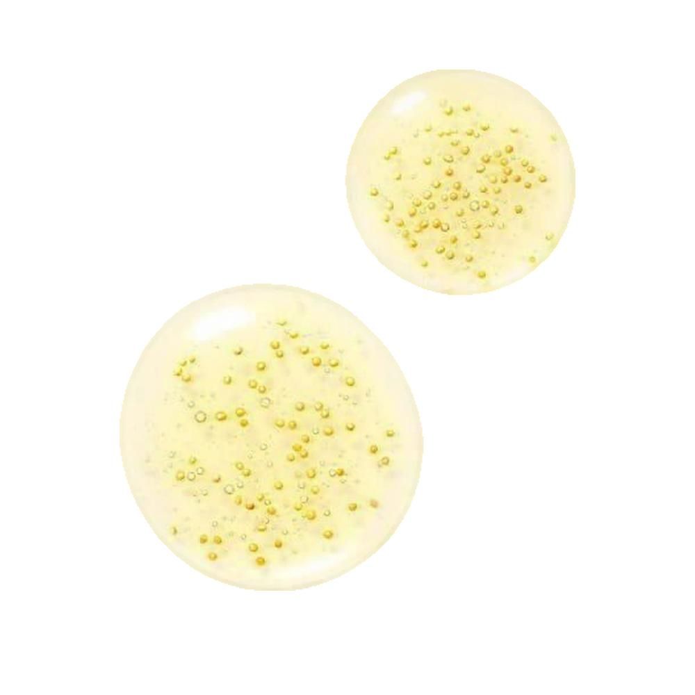 Zwei gelbliche Tropfen mit kleinen goldenen Kügelchen. Auf weißem Hintergrund.