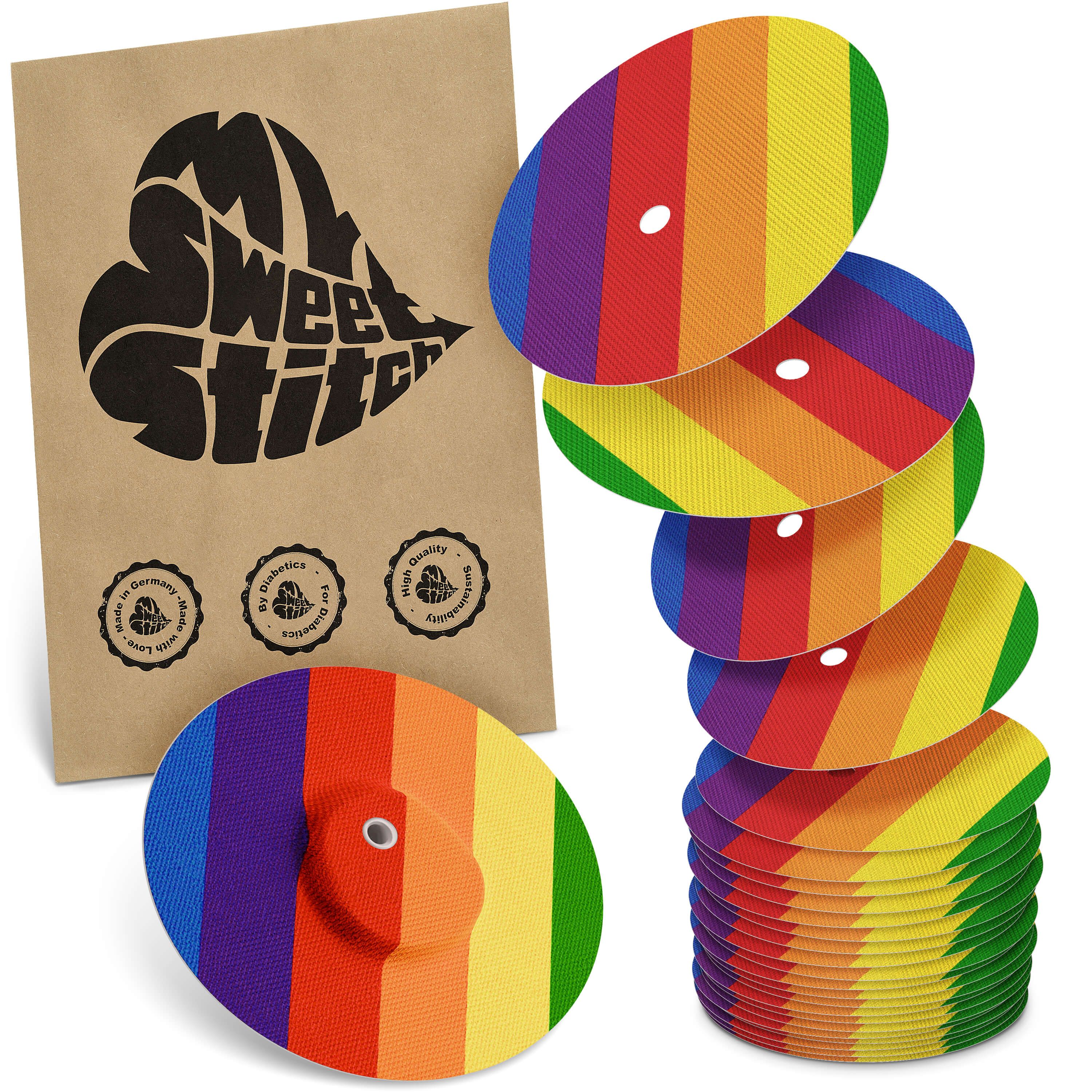 Fixierpflaster mit Regenbogenmuster. Braune Verpackung mit Logo. Mehrere Pflaster gestapelt und einzeln.