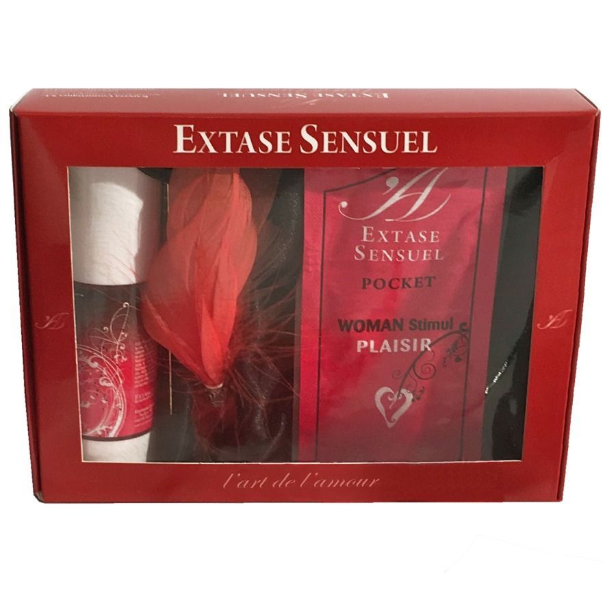 Geschenkbox mit Produkten. Sichtbar: Flasche, Feder, Päckchen. Aufschrift: Extase Sensuel, l'art de l'amour.