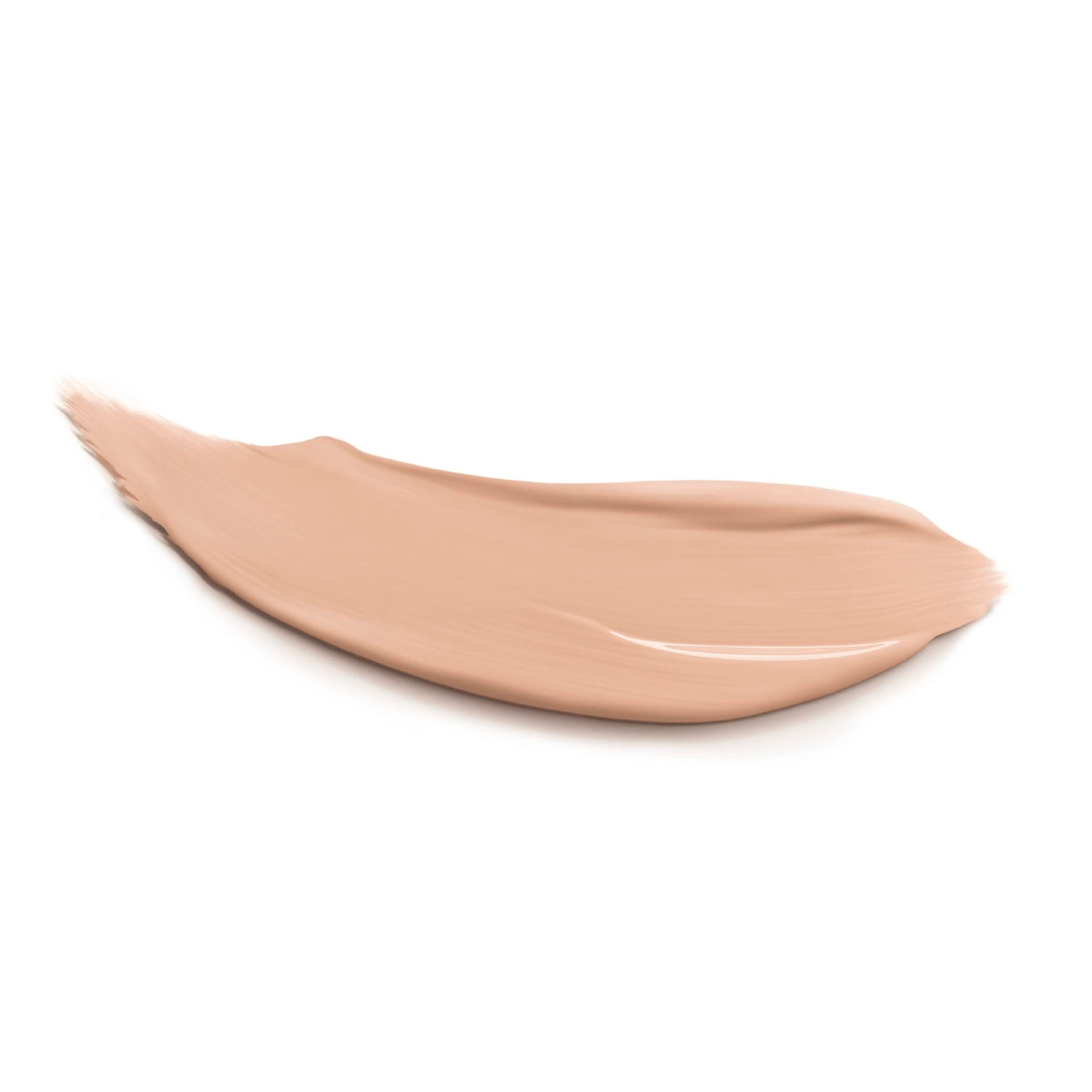 Beige Concealer-Strich auf weißem Hintergrund. Glänzende Textur.