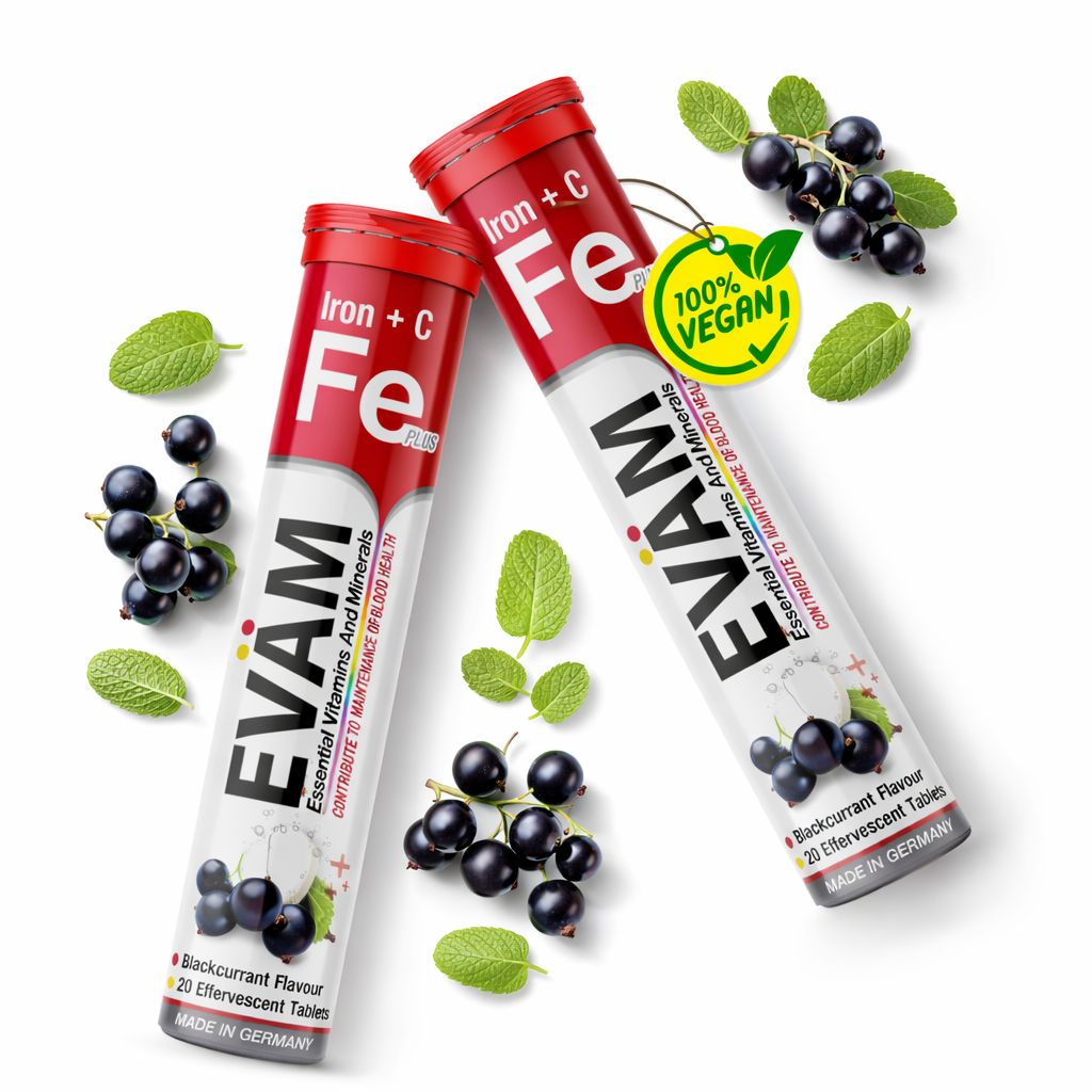 Zwei Tuben EVÄM Eisen + Vitamin C Brausetabletten, umgeben von schwarzen Johannisbeeren und Minze.