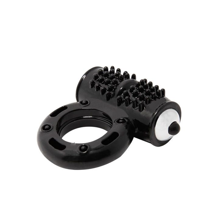 Schwarzer Vibrationsring mit Noppen und einem Vibrator-Aufsatz. Der Ring hat eine runde Form.