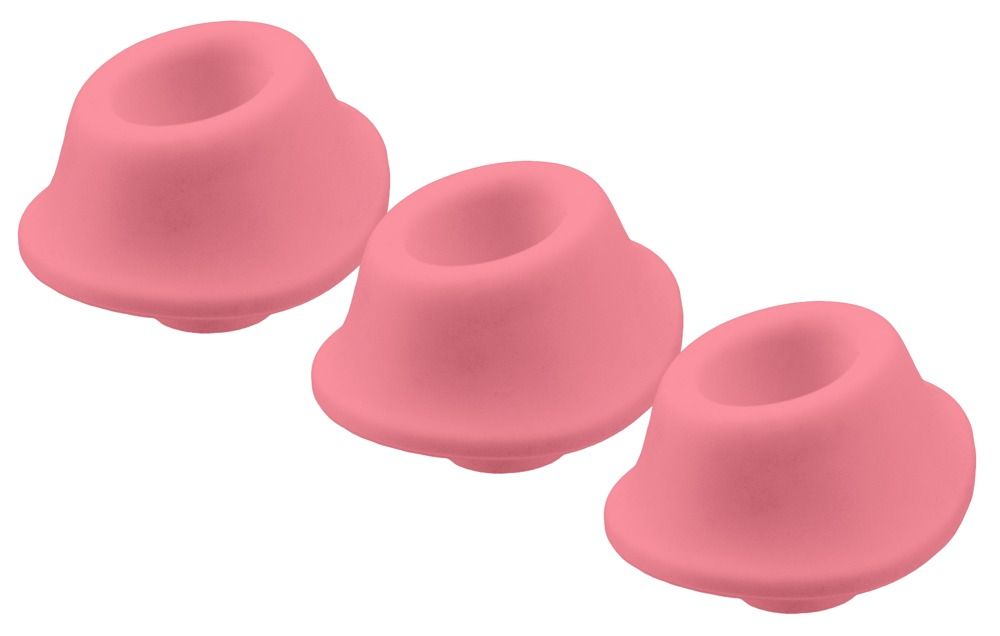 Drei rosa Ersatzkappen für Womanizer-Produkte.