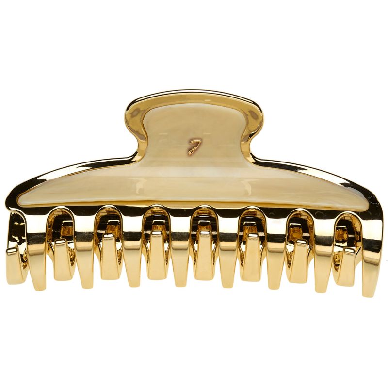 Haarspange in Goldoptik. Oberteil cremefarben, mit goldfarbenem Logo. Zähne zum Greifen. Glänzendes Material.