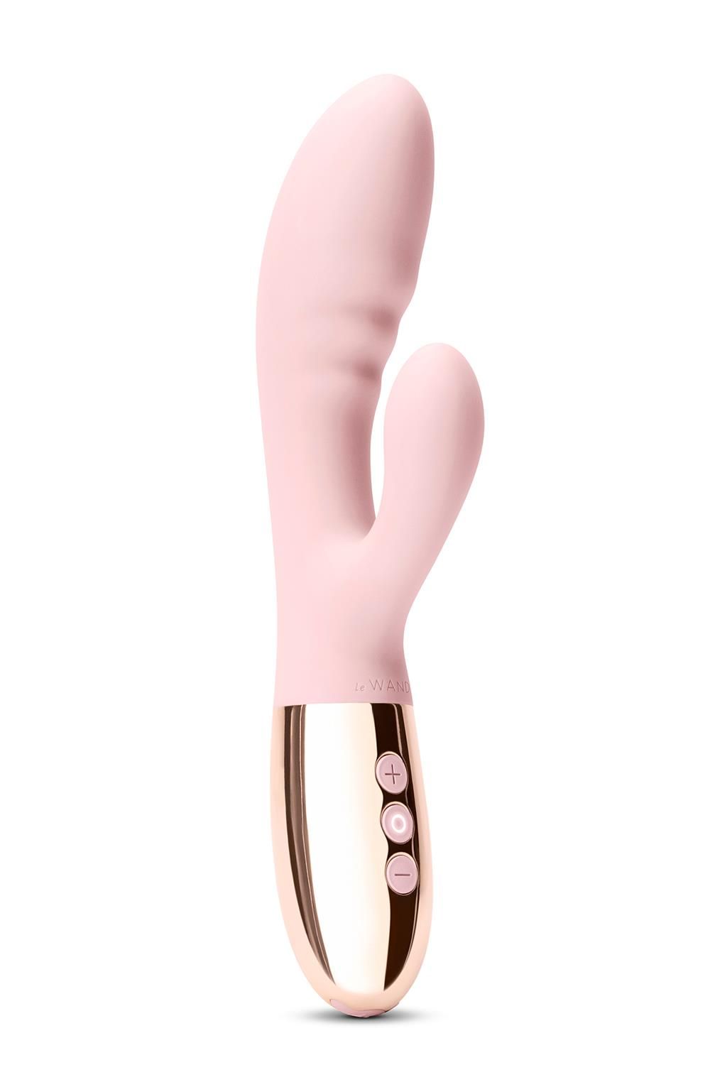 Rosa Vibrator mit goldfarbenem Sockel. Drei Knöpfe.  Der obere Teil hat eine gebogene Form.