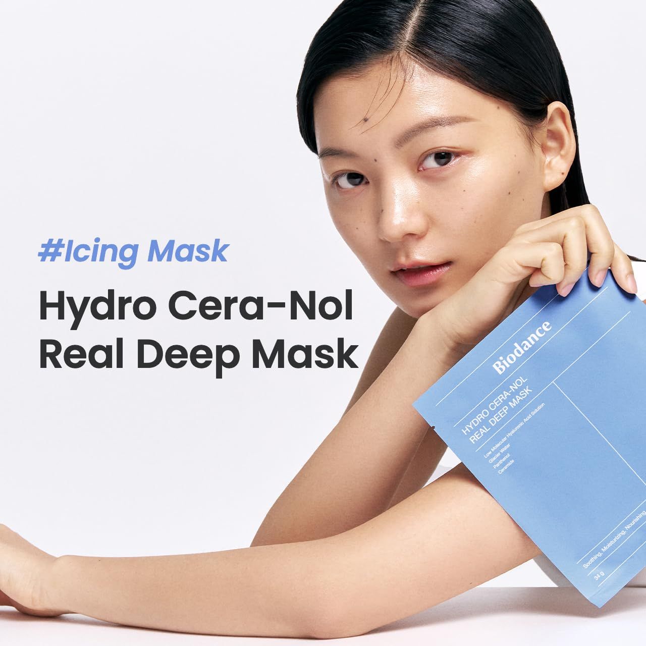 Frau hält blaue Biodance-Verpackung. Text: #Icing Mask, Hydro Cera-Nol Real Deep Mask. Gesicht mit heller Haut. Weißer Hintergrund.