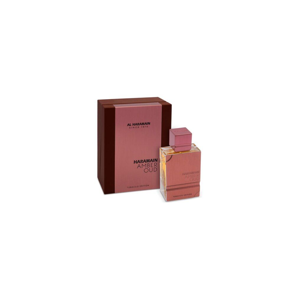 Parfümflasche und Verpackung. Aufschrift: Al Haramain, Amber Oud Tobacco Edition. Flasche und Box in Braun- und Goldtönen.