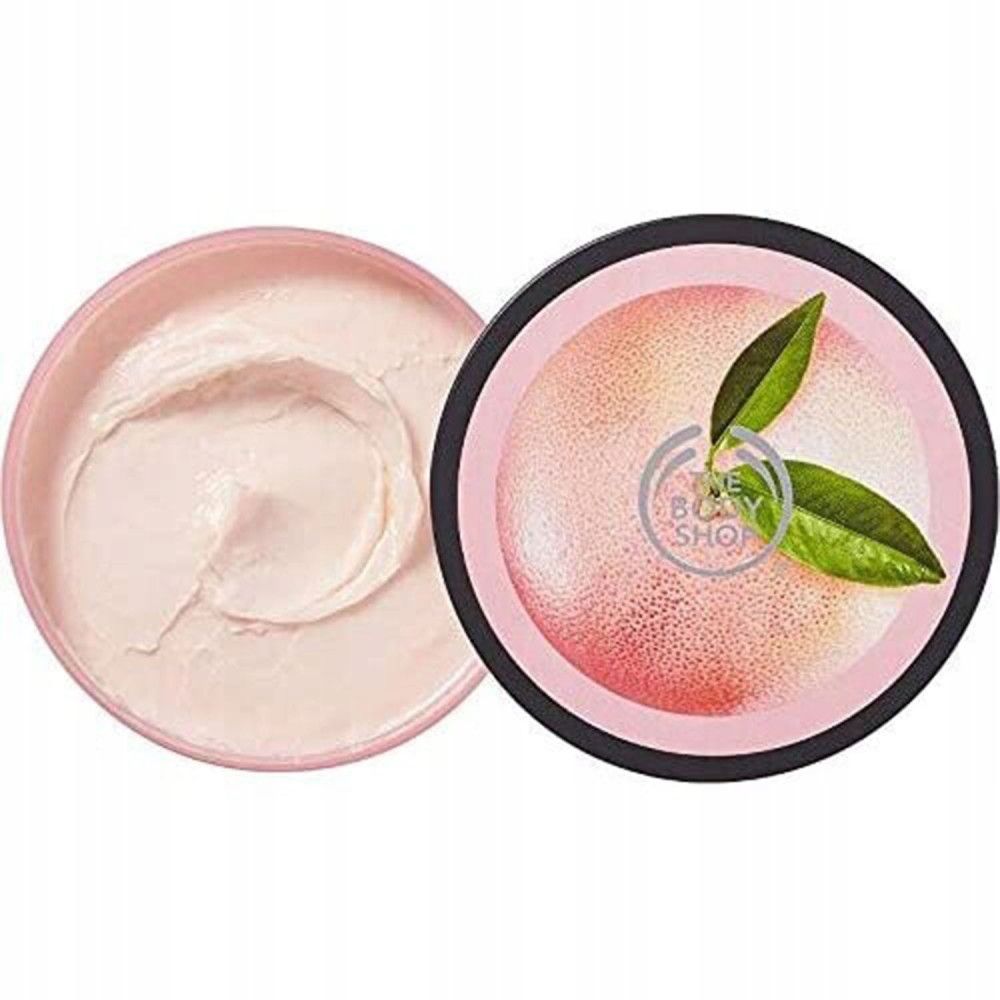 Geöffnete Dose Körperbutter. Rosa Creme, daneben der Deckel mit Grapefruit-Motiv und Logo.