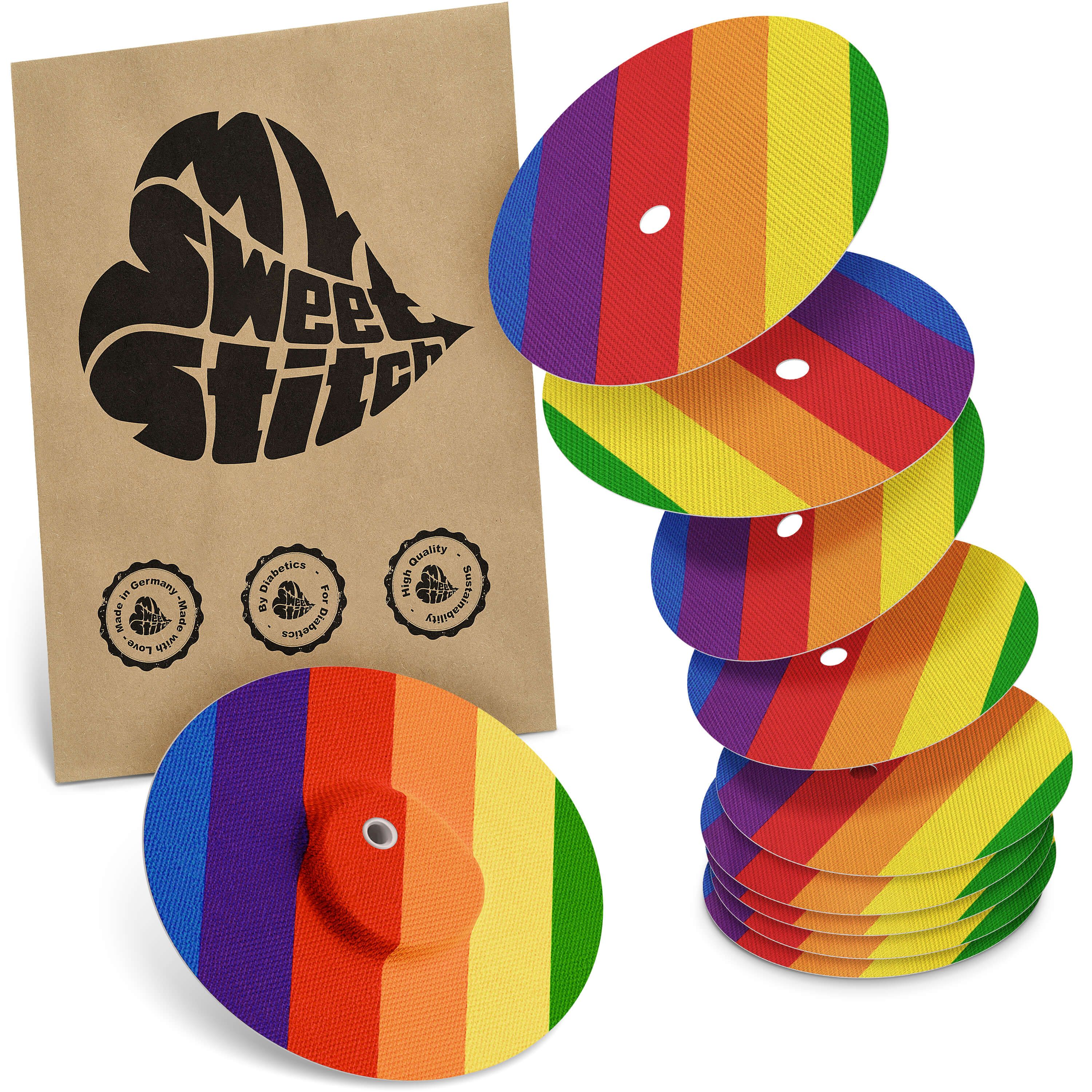 Mehrfarbige Pflaster, Regenbogenmuster, mit brauner Verpackung. Logo: MySweetStitch. Mehrere Pflaster gestapelt.