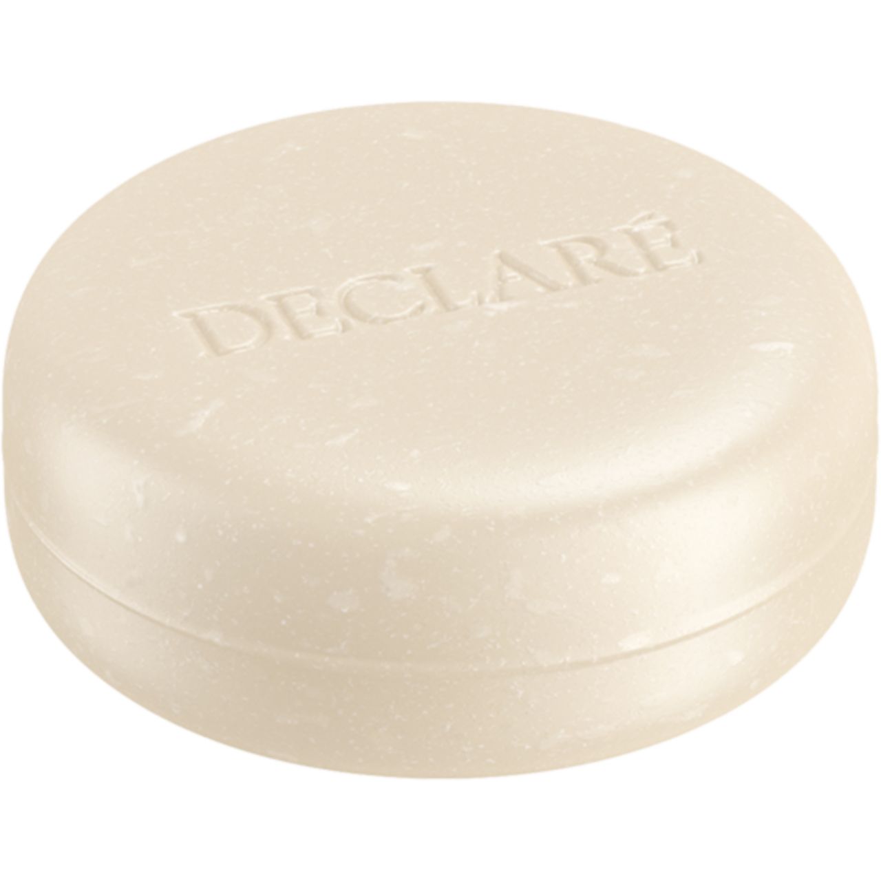 Runde Seife mit geprägtem DECLARE-Schriftzug. Helle Farbe, leicht gewölbte Form.