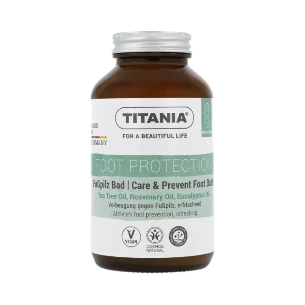 Braune Glasflasche mit silbernem Deckel. Etikett mit Text: TITANIA, FOOT PROTECTION, Fußpilz Bad. Vegan-Siegel.