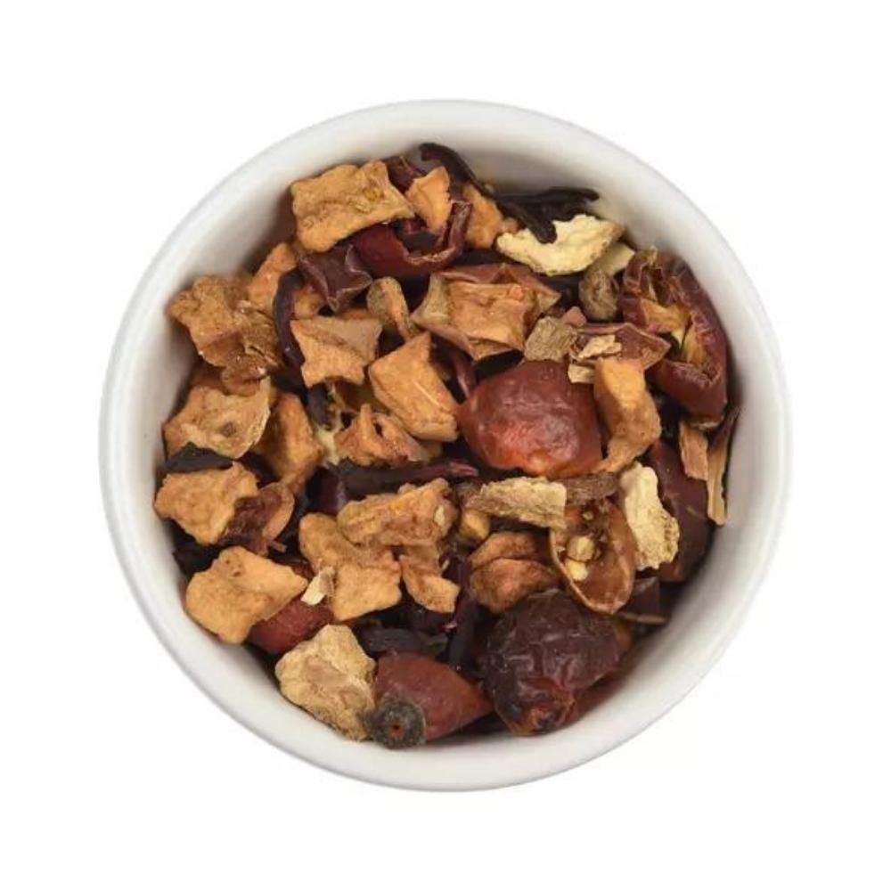 Lose Früchteteemischung in weißer Schale. Sichtbar sind getrocknete Apfelstücke, Hagebutten und weitere Zutaten.